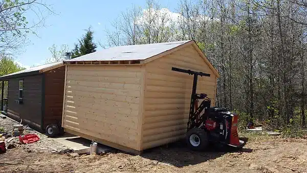 Shed moving equipment. Tan shed.