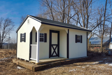 Wooden Backyard Shed - White wood siding with black-trimmed door and corners - three visible windows with black shutters