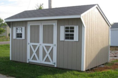 Backyard shed - taupe painted wood siding with white-trimmed double doores and matching shutters on two windows beneath dark gray roof