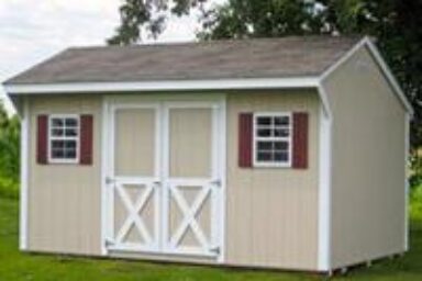 Backyard shed - beige with white-trimmed double doors and white windows with burgundy shutters beneath brown shingled roof